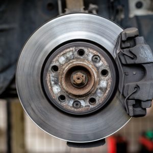 front brake discs with caliper and brake pads in the car on a car lift in a workshop front repair car t20 YwznEO